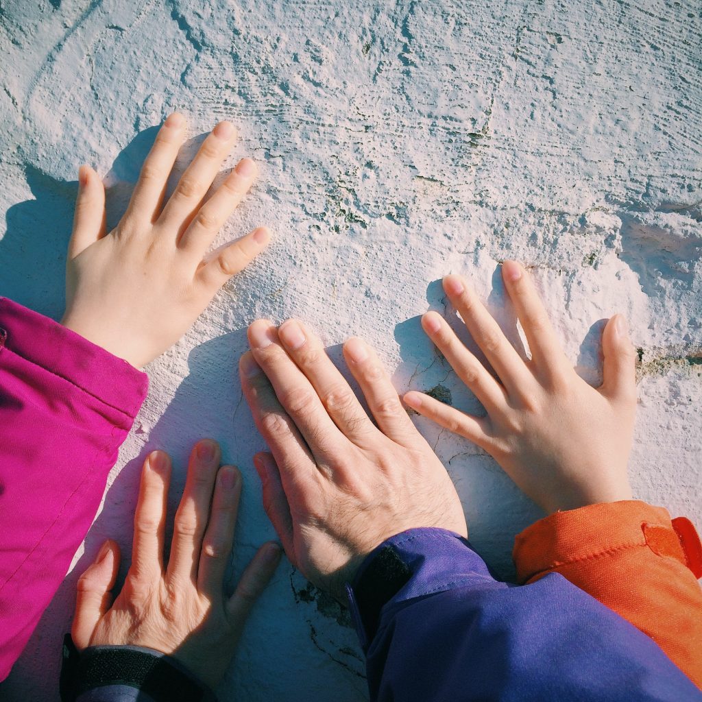 Family hands on a monument